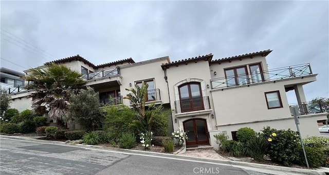 304 27th St, Manhattan Beach, CA 90266 - mediterranean / spanish-style home featuring french doors, a balcony, and stucco siding
