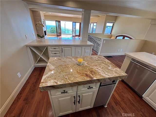 304 27th St, Manhattan Beach, CA 90266 - kitchen featuring dark wood-type flooring, white cabinets, stainless steel dishwasher, and light stone countertops