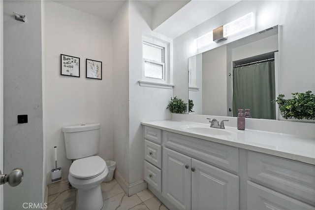 bathroom with toilet, marble finish floor, baseboards, and vanity