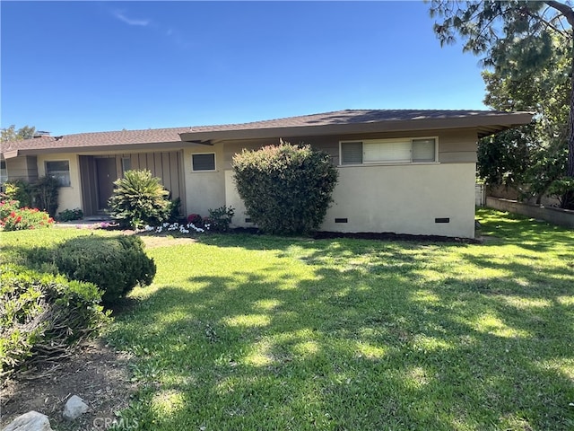 ranch-style home with a front yard and crawl space