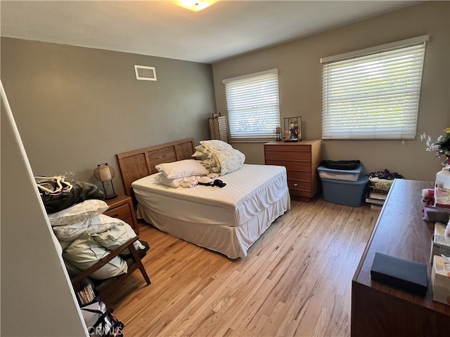 bedroom featuring light wood-style flooring and visible vents