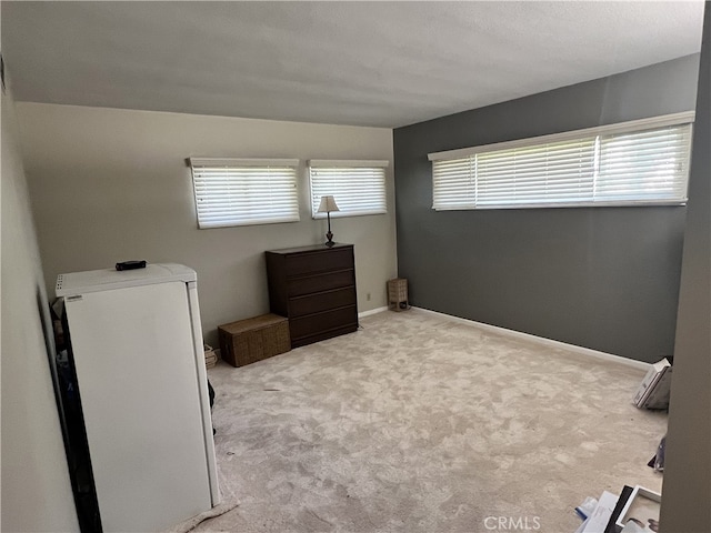 carpeted bedroom featuring baseboards