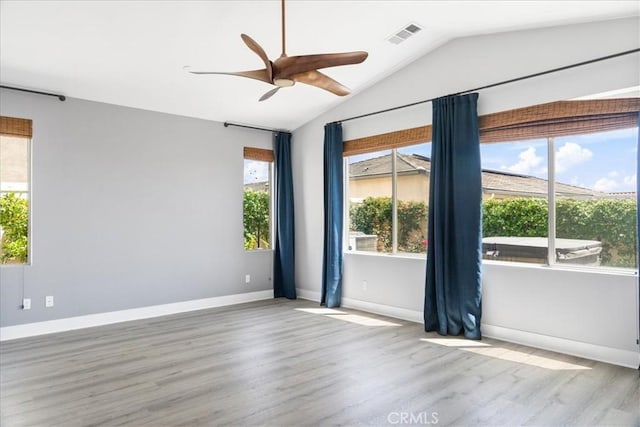 unfurnished room with baseboards, ceiling fan, wood finished floors, and lofted ceiling