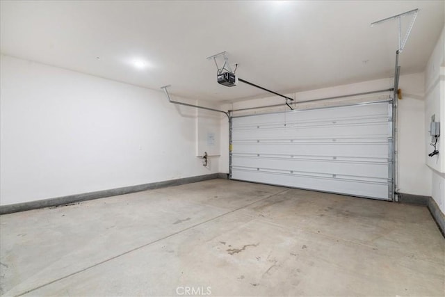 garage with baseboards and a garage door opener