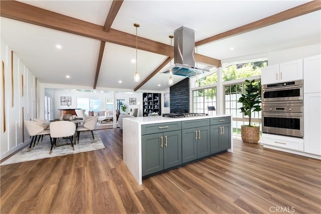 22838 Epsilon St, Woodland Hills, CA 91364 - kitchen with island exhaust hood, appliances with stainless steel finishes, light countertops, dark wood-style flooring, and recessed lighting