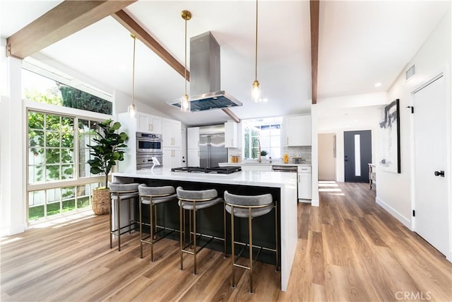 22838 Epsilon St, Woodland Hills, CA 91364 - kitchen with island range hood, built in refrigerator, beam ceiling, white cabinetry, and light countertops