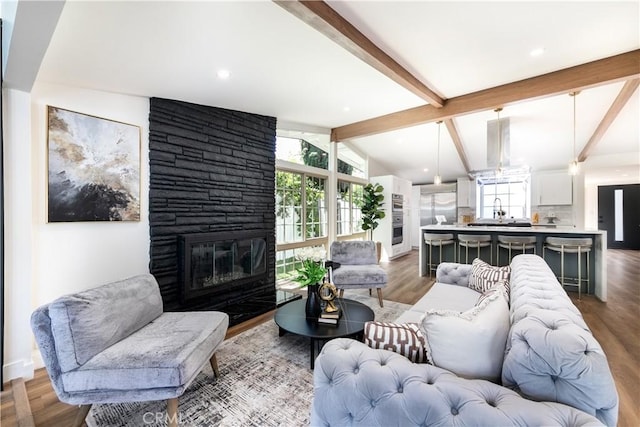 22838 Epsilon St, Woodland Hills, CA 91364 - living area featuring healthy amount of natural light, a fireplace, and wood finished floors