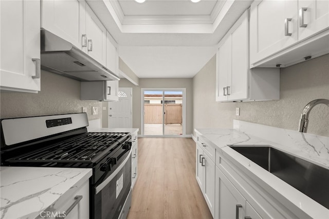 26497 Calle San Francisco Unit 60F, San Juan Capistrano, CA 92675 - kitchen featuring white cabinets, a sink, stainless steel gas stove, light wood-style flooring, and under cabinet range hood