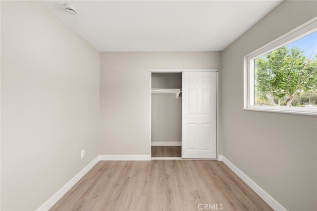26497 Calle San Francisco Unit 60F, San Juan Capistrano, CA 92675 - unfurnished bedroom featuring light wood-type flooring, baseboards, and a closet