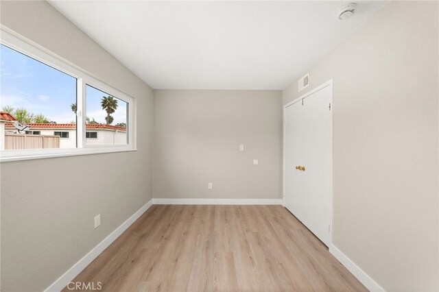26497 Calle San Francisco Unit 60F, San Juan Capistrano, CA 92675 - unfurnished room with visible vents, light wood-style flooring, and baseboards