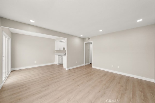 26497 Calle San Francisco Unit 60F, San Juan Capistrano, CA 92675 - unfurnished living room featuring light wood-style floors, baseboards, recessed lighting, and visible vents