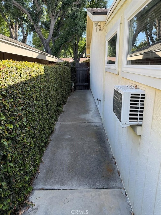 view of property exterior with cooling unit and fence