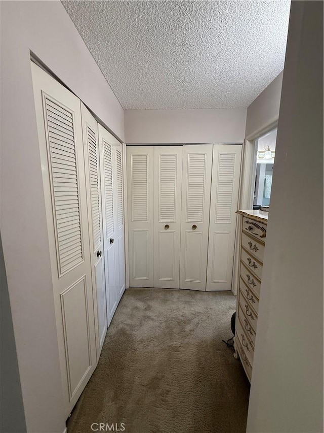 unfurnished bedroom with carpet and a textured ceiling