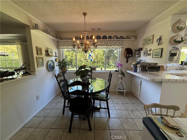 dining room featuring a chandelier, a wealth of natural light, visible vents, and ornamental molding