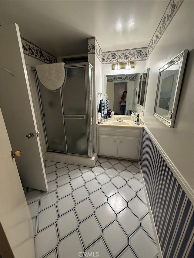 bathroom featuring a stall shower and vanity