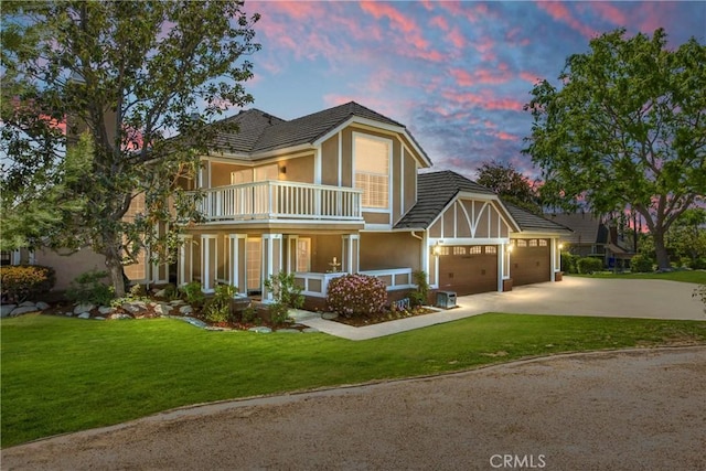 880 E 24th St, Upland, CA 91784 - view of front of house with a balcony, stucco siding, a yard, and concrete driveway