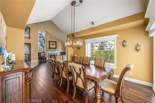 880 E 24th St, Upland, CA 91784 - dining area featuring a warm lit fireplace, high vaulted ceiling, dark wood-type flooring, a chandelier, and baseboards