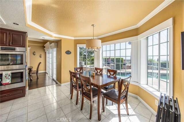 880 E 24th St, Upland, CA 91784 - dining room featuring a textured ceiling, baseboards, crown molding, light tile patterned floors, and a chandelier