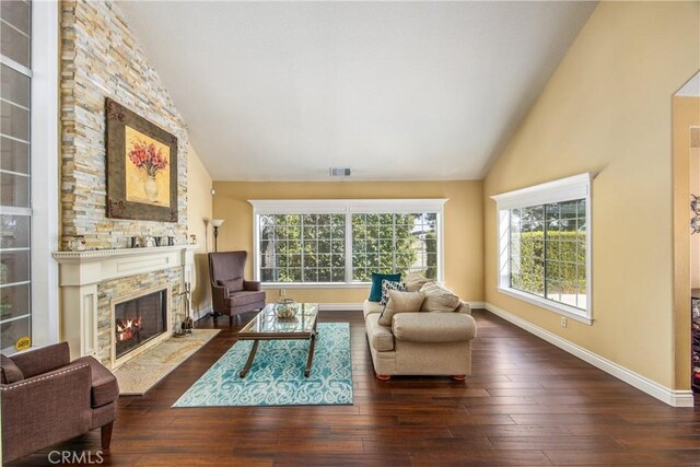 880 E 24th St, Upland, CA 91784 - living room with a stone fireplace, wood finished floors, baseboards, and high vaulted ceiling
