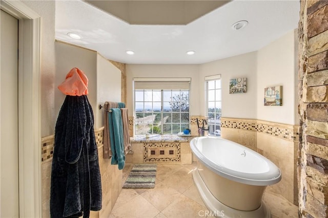 880 E 24th St, Upland, CA 91784 - full bathroom featuring a freestanding bath, a wainscoted wall, recessed lighting, tile walls, and tile patterned floors