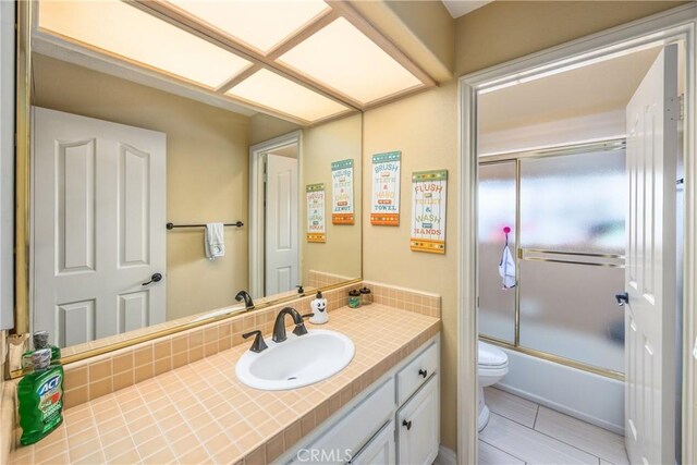 880 E 24th St, Upland, CA 91784 - bathroom featuring toilet, vanity, and combined bath / shower with glass door