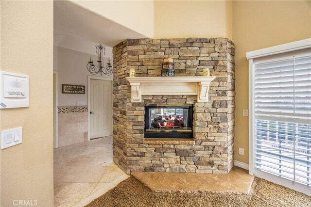 880 E 24th St, Upland, CA 91784 - detailed view of a stone fireplace and a chandelier