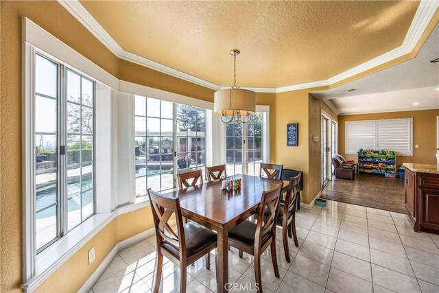 880 E 24th St, Upland, CA 91784 - dining area with a textured ceiling, ornamental molding, baseboards, a chandelier, and light tile patterned flooring