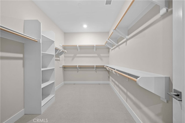 walk in closet featuring visible vents and carpet