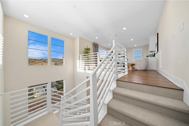 stairs featuring recessed lighting