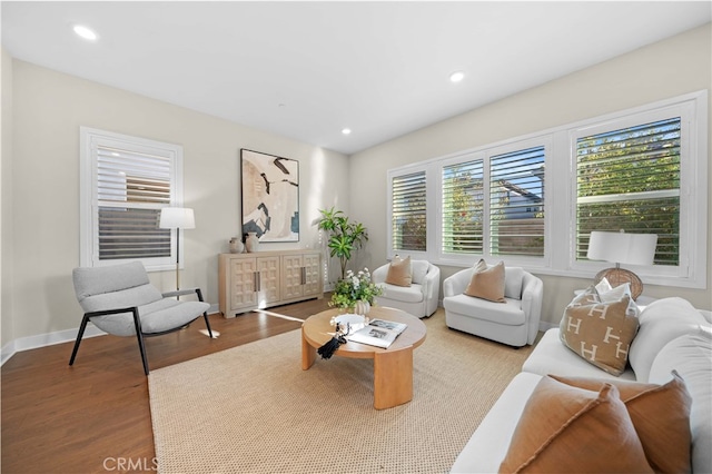 living room with baseboards, recessed lighting, and wood finished floors