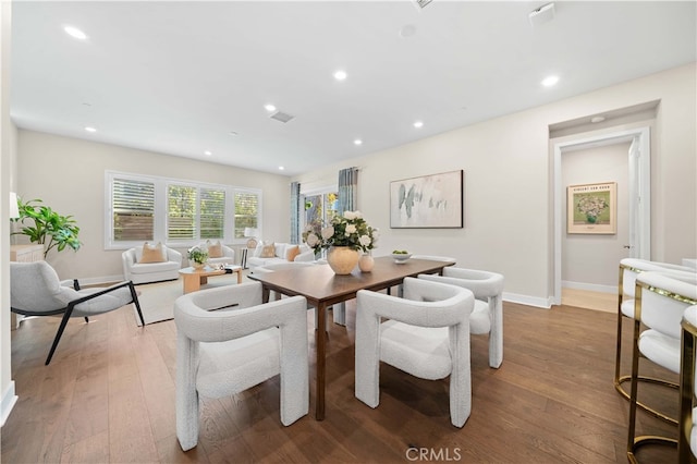 dining area featuring hardwood / wood-style floors, baseboards, visible vents, and recessed lighting