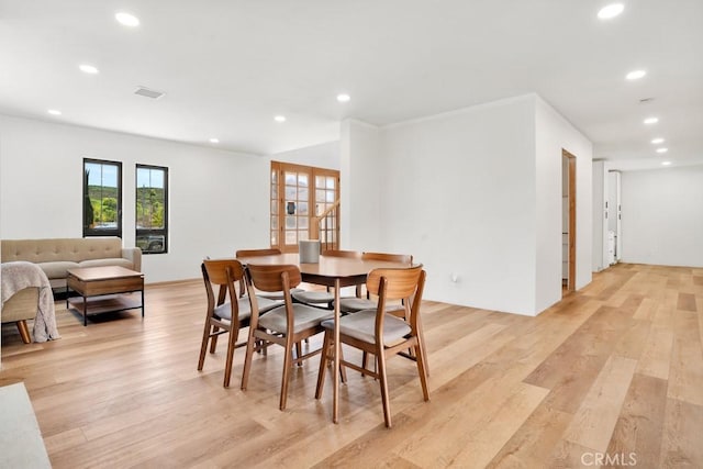 dining space with light wood-style flooring, visible vents, and recessed lighting