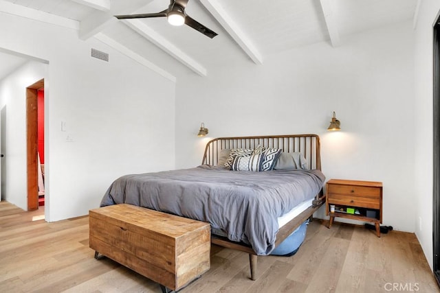 bedroom with light wood-type flooring, ceiling fan, vaulted ceiling with beams, and visible vents