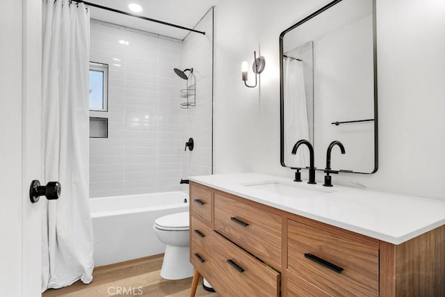 bathroom with shower / bath combo, vanity, toilet, and wood finished floors