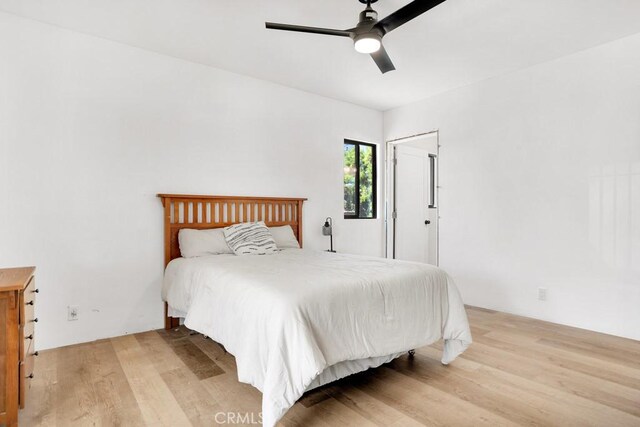 bedroom featuring light wood-style floors and ceiling fan