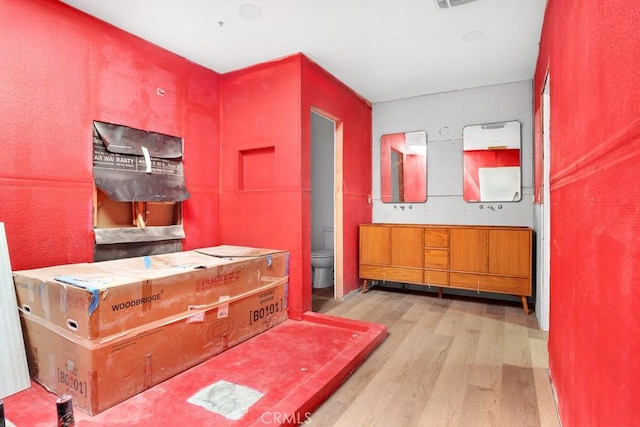 interior space with wood finished floors and visible vents