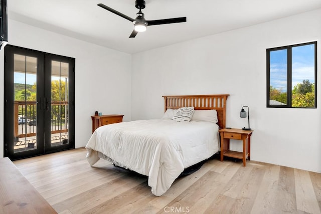 bedroom featuring light wood finished floors, french doors, access to exterior, and a ceiling fan