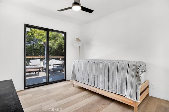bedroom with access to exterior, a ceiling fan, and wood finished floors