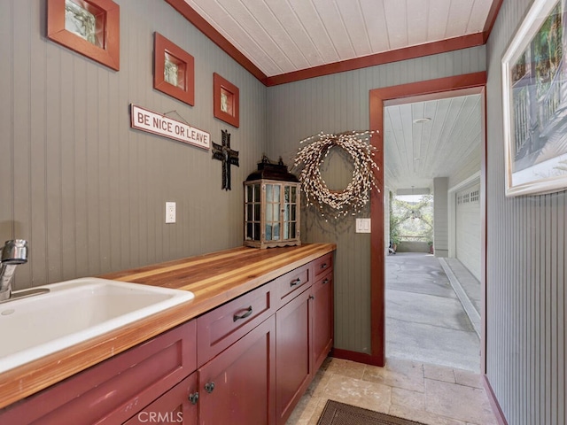 interior space featuring a sink, crown molding, and stone finish flooring