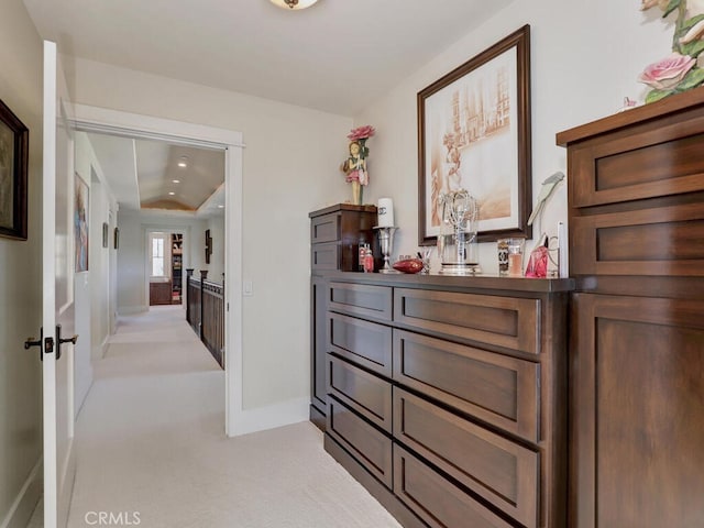 corridor with light colored carpet and baseboards