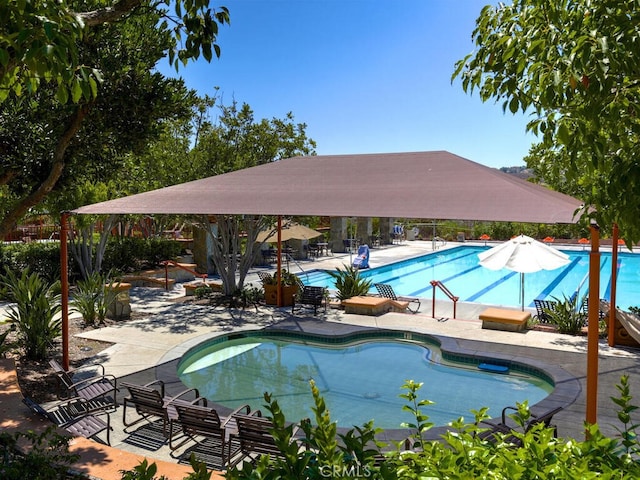 community pool featuring a patio area