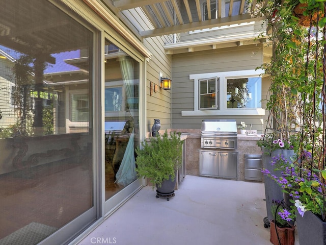 view of patio featuring a grill, area for grilling, and a sink