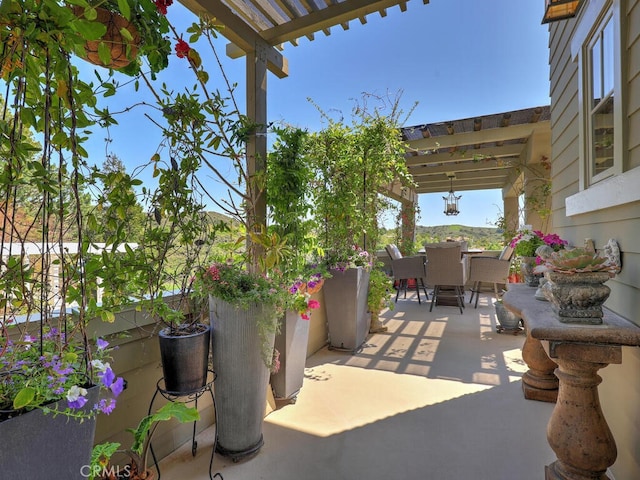 view of patio / terrace with outdoor dining space and a pergola