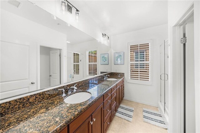 35 Jonquil, Irvine, CA 92618 - full bathroom featuring a stall shower, double vanity, baseboards, and tile patterned floors