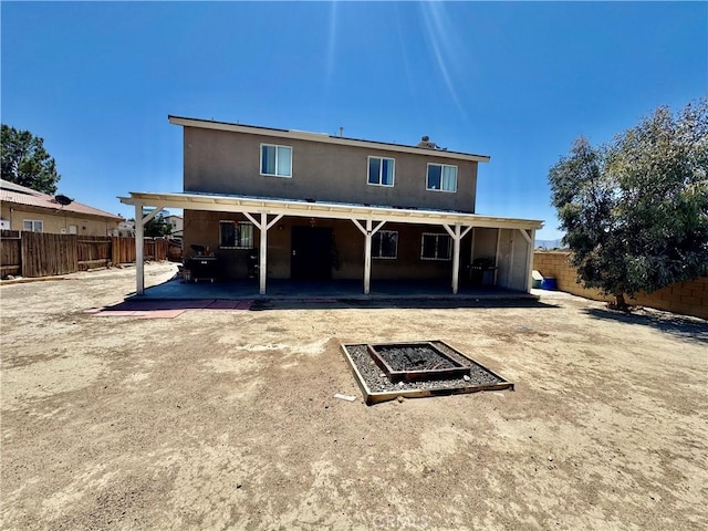 10506 Lee Ave, Adelanto, CA 92301 - rear view of property with a fenced backyard, a patio area, and stucco siding