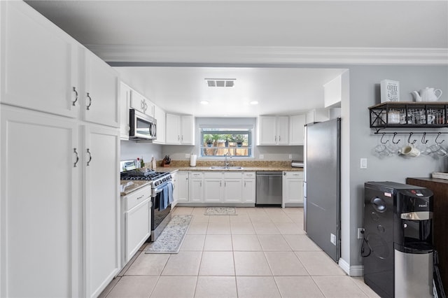 kitchen featuring stainless steel appliances, visible vents, white cabinets, and a sink