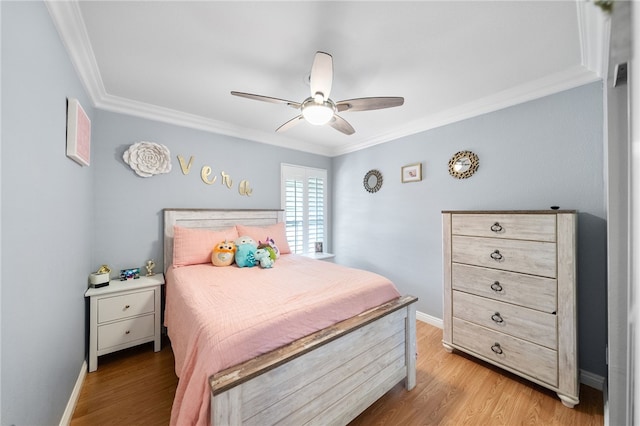 bedroom with crown molding, baseboards, and light wood-type flooring