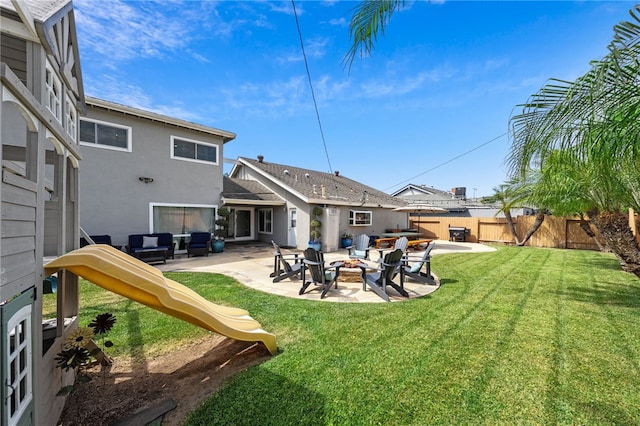 exterior space featuring a yard, stucco siding, an outdoor fire pit, a patio, and fence