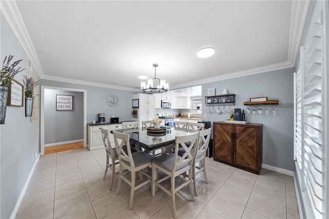 dining space featuring light tile patterned floors, a notable chandelier, baseboards, and ornamental molding