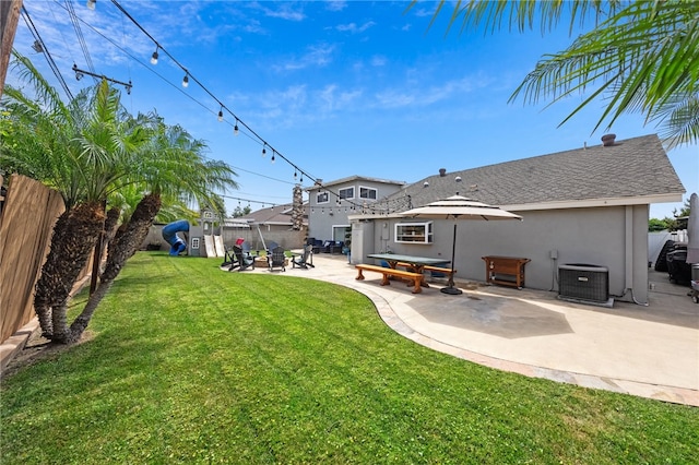 view of yard featuring a patio area, central AC unit, and a fenced backyard